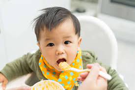 baby eating rice cereal